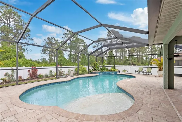Pool featuring a patio and glass enclosure