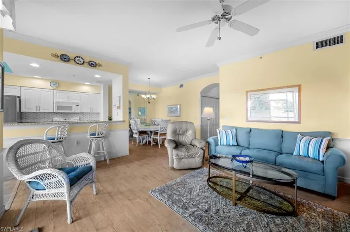 Sunroom / solarium with golf course view and ceiling fan