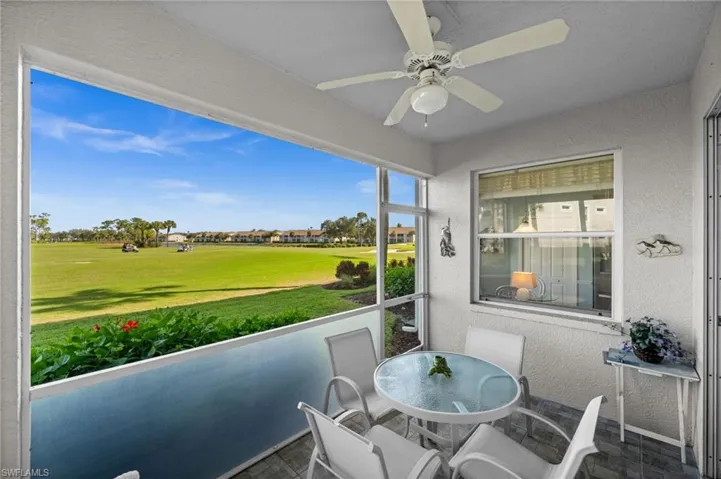 Sunroom / solarium with outdoor dining area and a ceiling fan