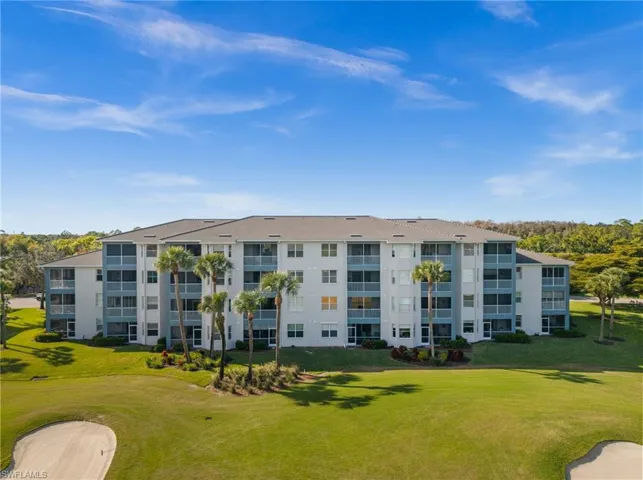 Hall featuring arched walkways, light tile patterned floors, and crown molding