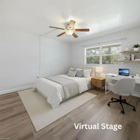 Bright room featuring wood-finish flooring and a ceiling fan with integrated lighting