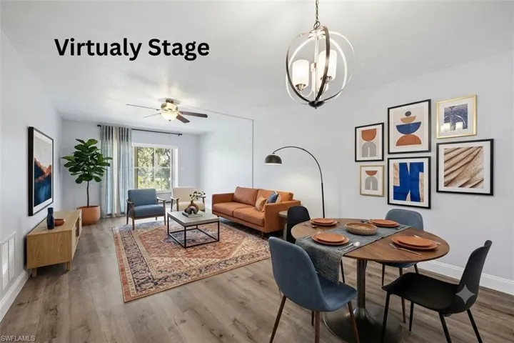 Open-concept living area featuring wood-finish flooring, a contemporary ceiling fan, and a modern orb chandelier