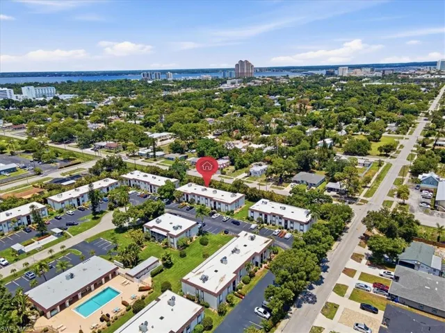 Aerial perspective showcasing multiple residential buildings with surrounding green spaces