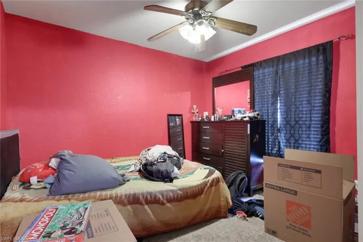 Bedroom with ceiling fan and carpet floors