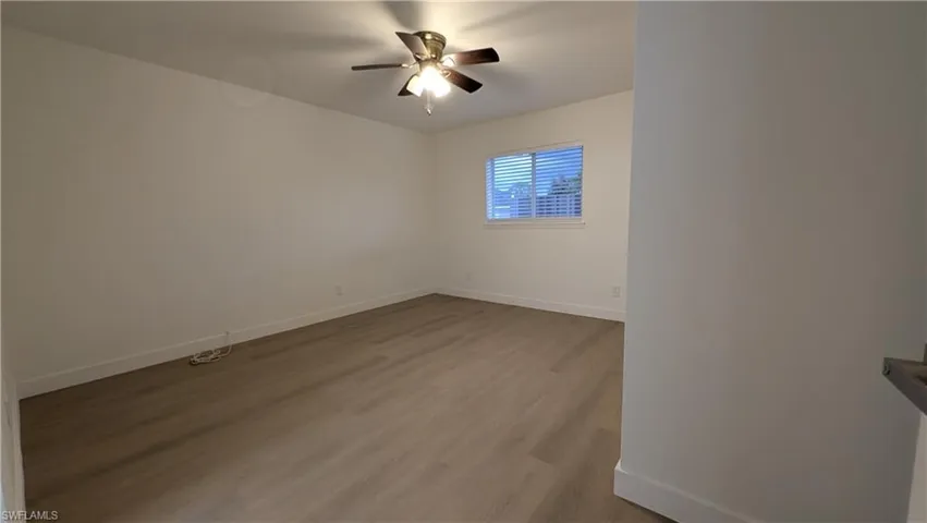 Unfurnished room featuring light wood-style floors and ceiling fan