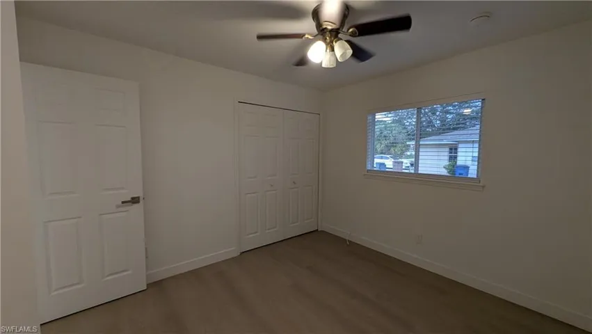 Unfurnished bedroom with light wood-style floors, ceiling fan, and a closet