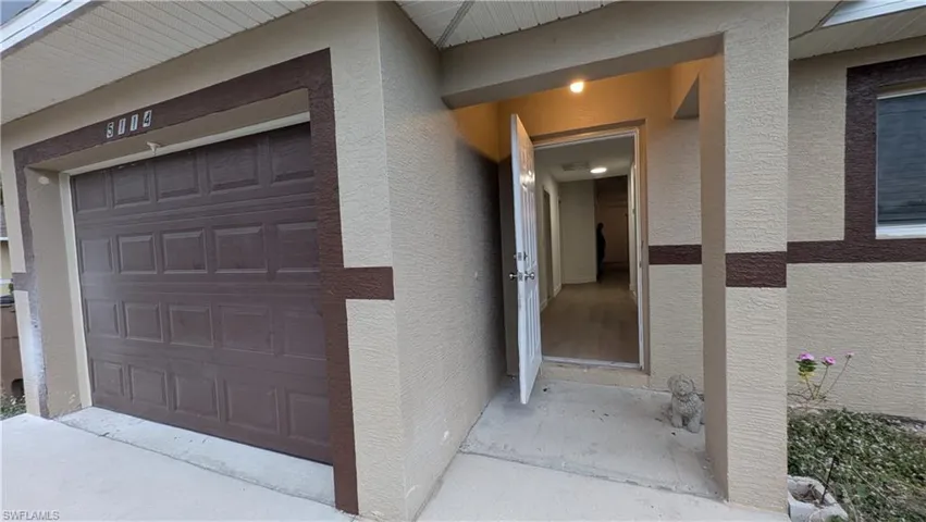 Property entrance featuring stucco siding