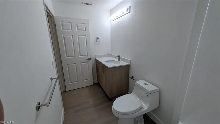 Bathroom with vanity and dark wood-style floors