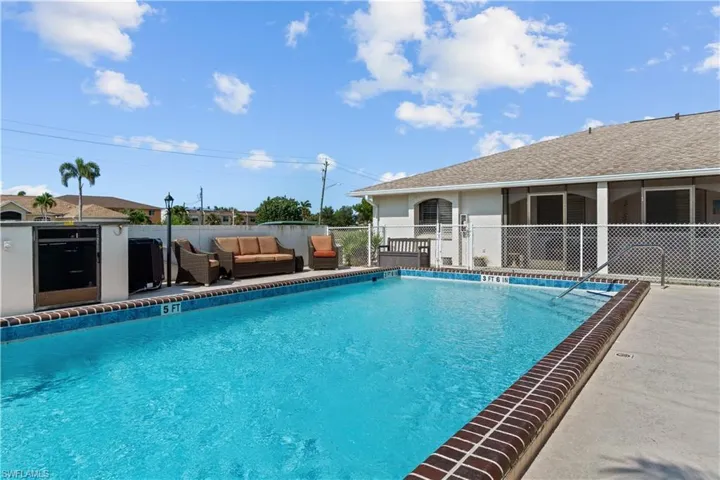 Community pool featuring a patio, outdoor lounge area, and a sunroom