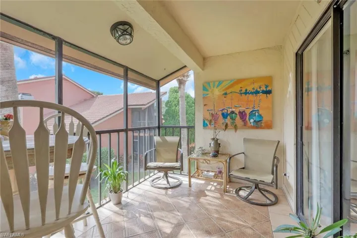 Sunroom with a wall of windows and tile patterned flooring