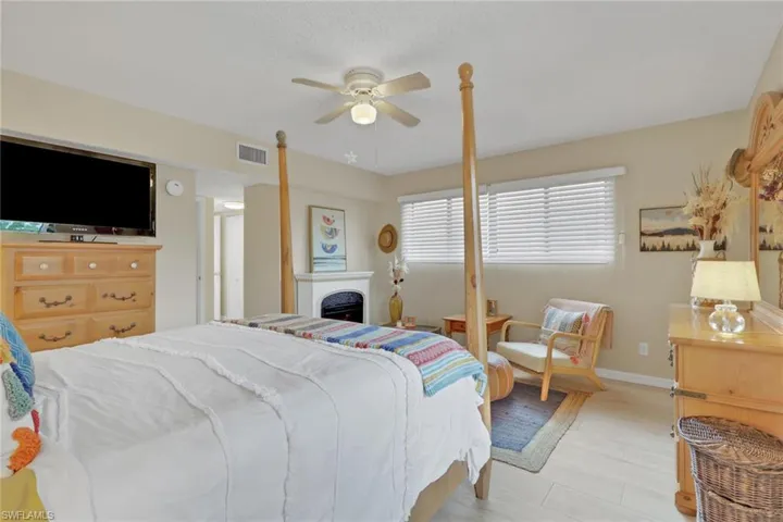 Bedroom with a ceiling fan and light wood-style floors