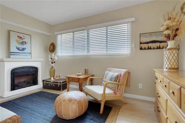 Sitting room with a fireplace and light wood-type flooring