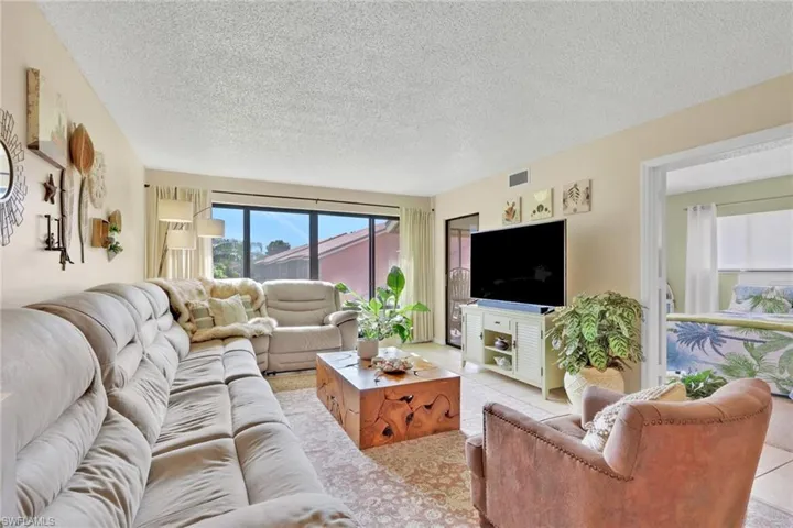 Living area featuring a textured ceiling and tile patterned flooring