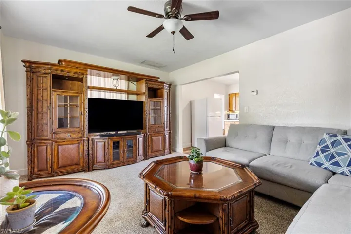 Living room with carpet and ceiling fan