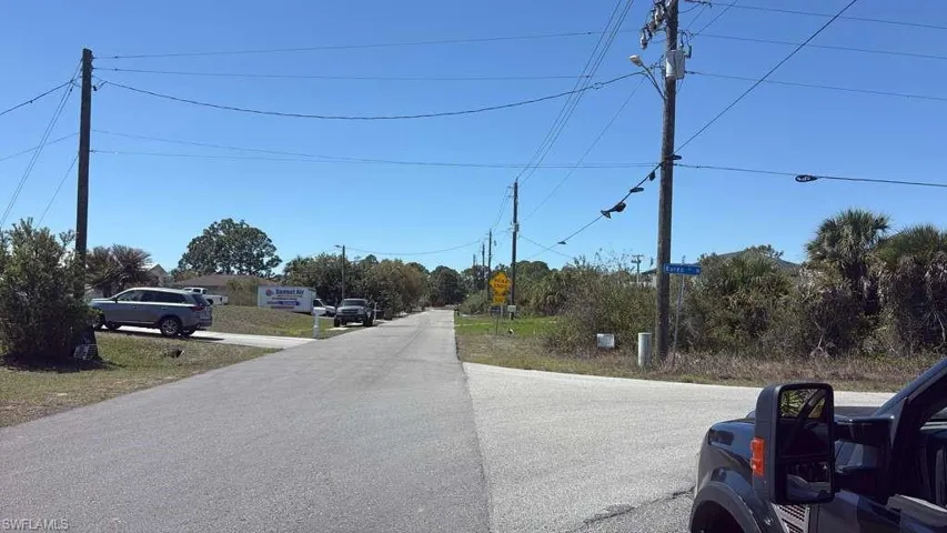 View of asphalt road featuring traffic signs