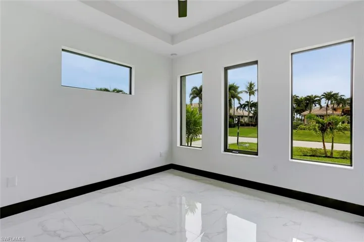 Tiled spare room with a healthy amount of sunlight