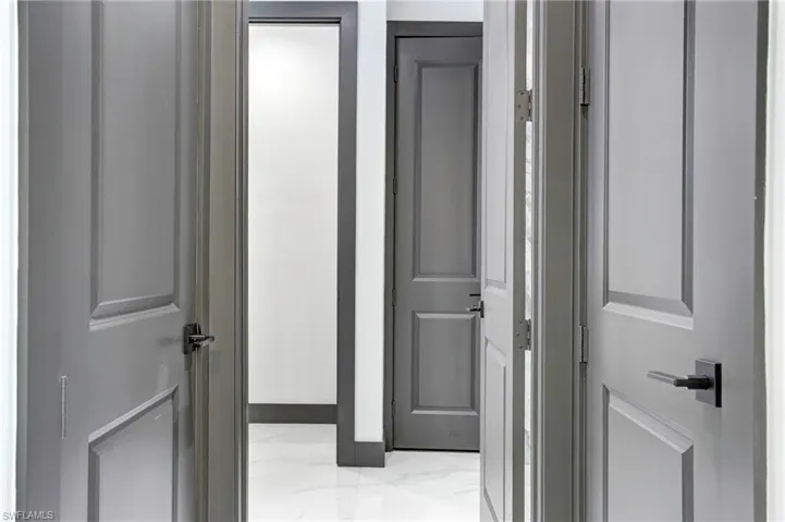 Hallway featuring light tile patterned floors