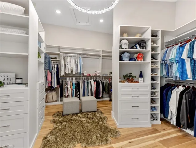 Walk in closet with light wood-type flooring