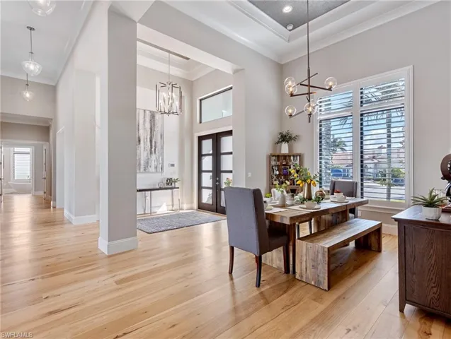 Dining area featuring french doors, a healthy amount of sunlight, and ornamental molding