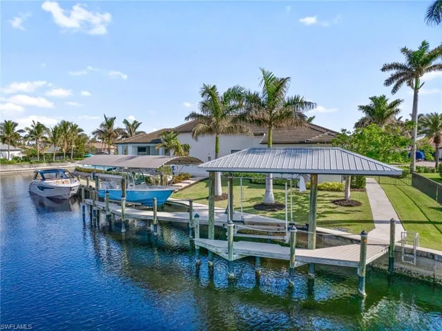 View of dock featuring a yard and a water view