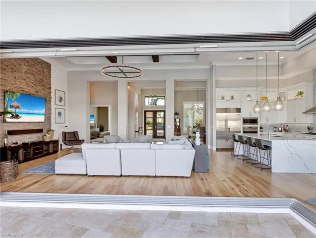 Living room featuring a towering ceiling and an inviting chandelier