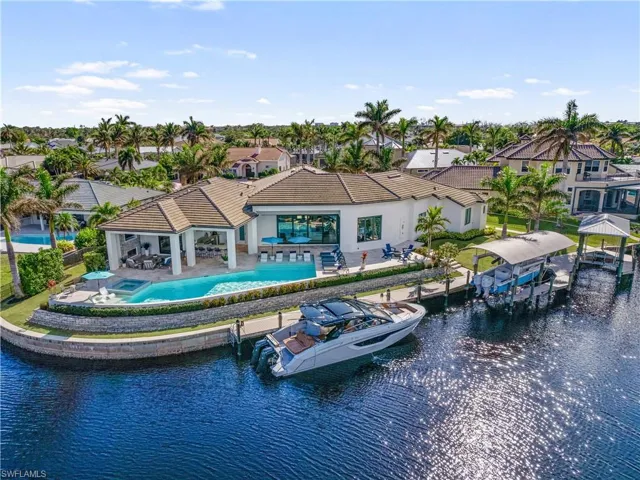 Rear view of house featuring a water view and a patio area
