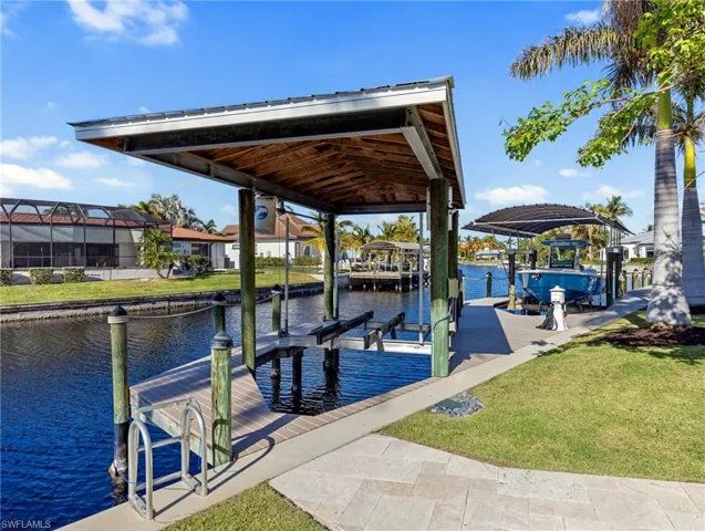 Dock area featuring a water view and a yard