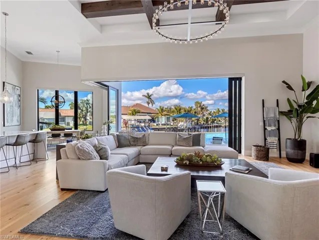 Living room with beam ceiling and hardwoodflooring