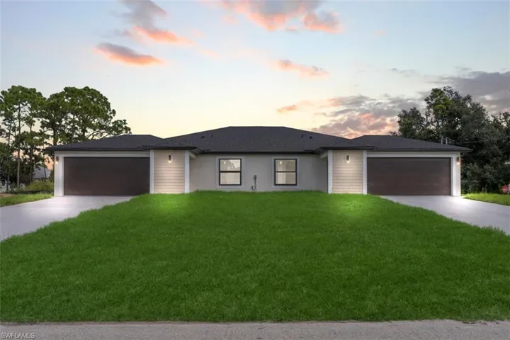 Single-story exterior featuring a neutral stucco facade, twin dark-finish garages, dual driveways, and dark shingle roofing