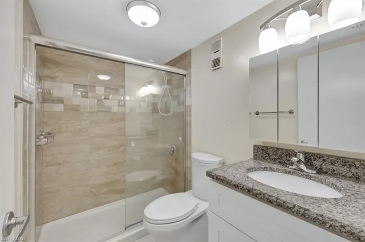 Full bathroom featuring vanity and a shower stall