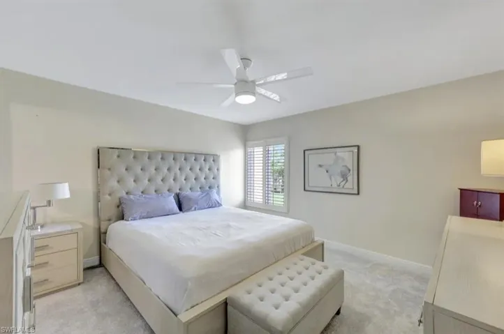 Bedroom with light carpet and ceiling fan