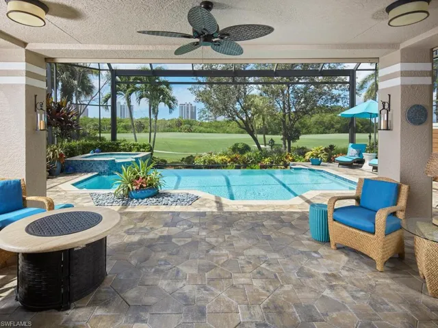 View of pool featuring a lanai, ceiling fan, an in ground hot tub, and a patio area