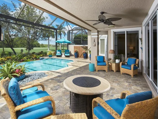 View of swimming pool with a lanai, a patio, and ceiling fan