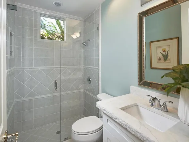 Bathroom with walk in shower, vanity, and toilet