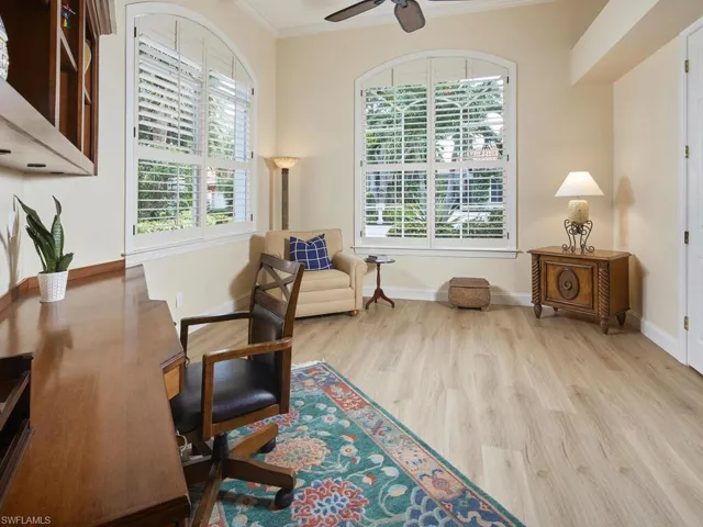 Office area featuring ceiling fan, light hardwood / wood-style flooring, and ornamental molding