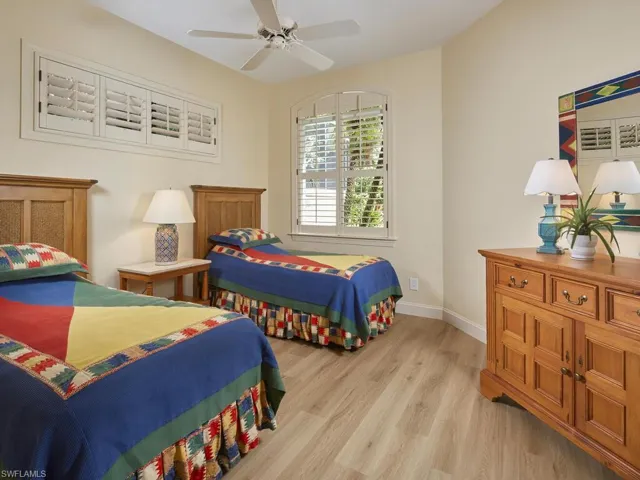 Bedroom featuring ceiling fan and light hardwood / wood-style flooring