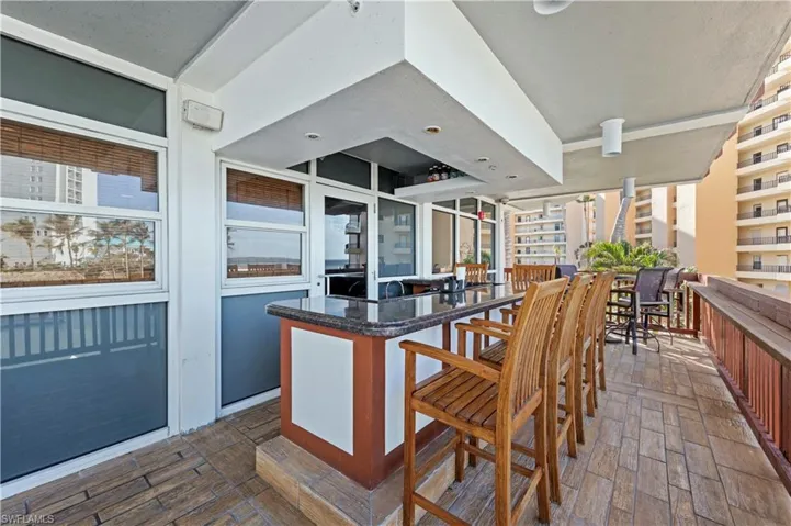 Kitchen featuring plenty of natural light, dark hardwood / wood-style flooring, a center island, and a breakfast bar area