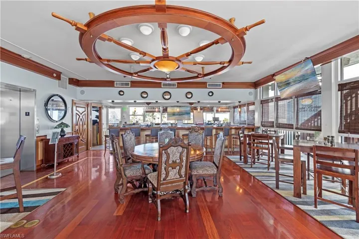 Dining area featuring elevator and wood-type flooring