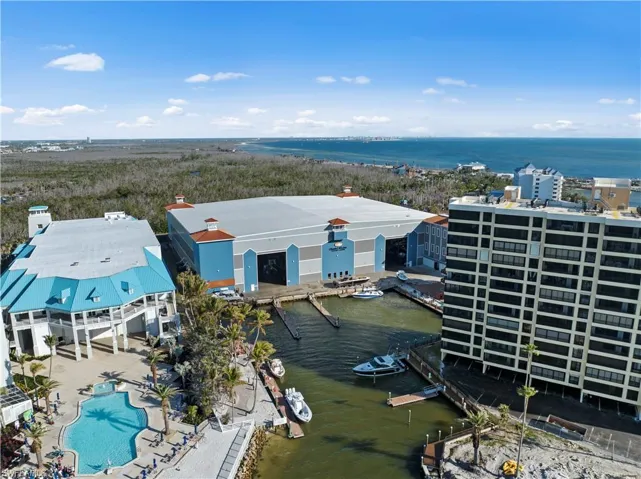 Birds eye view of property with a water view