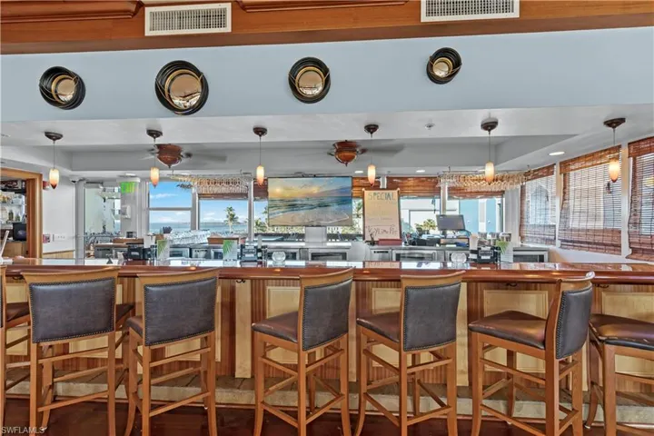 Kitchen featuring decorative light fixtures and a breakfast bar