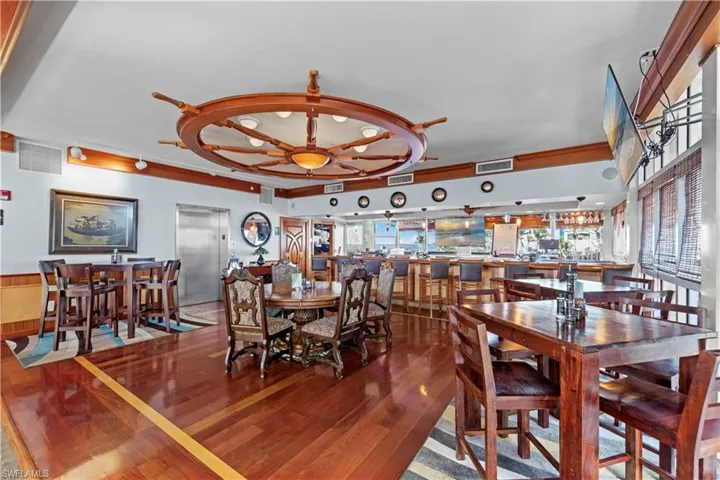 Dining room with hardwood / wood-style flooring and wooden walls