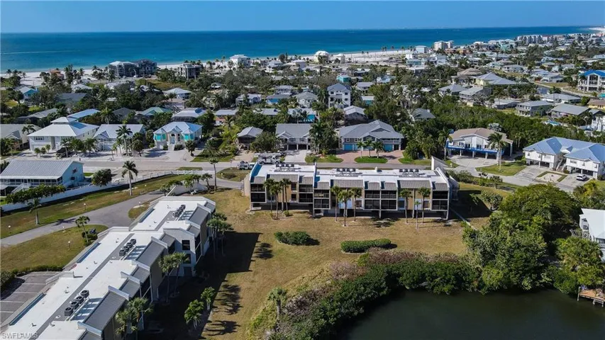 Aerial view of property and surrounding area with a nearby body of water
