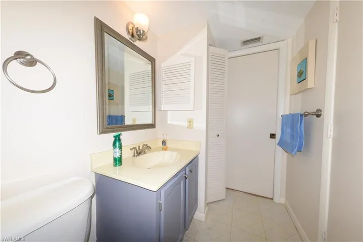 Guest Bathroom featuring vanity and a linen closet