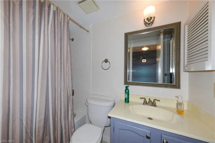 Guest Full bath with shower / bath combo with shower curtain and vanity
