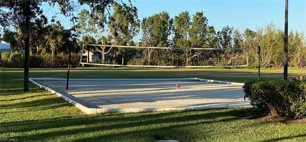 View of property's community featuring a lawn and volleyball court