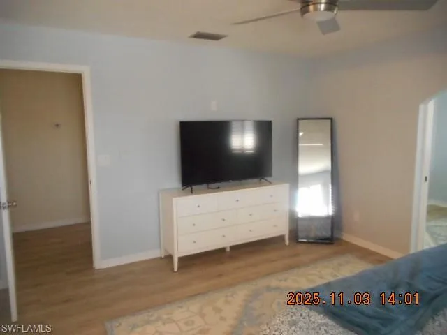 Bedroom with light wood finished floors and a ceiling fan