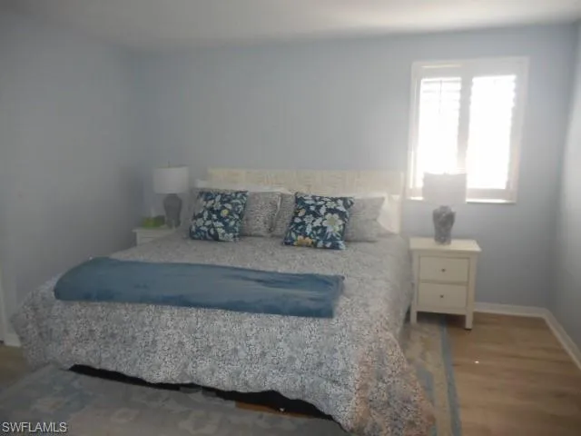 Bedroom featuring dark wood-style floors