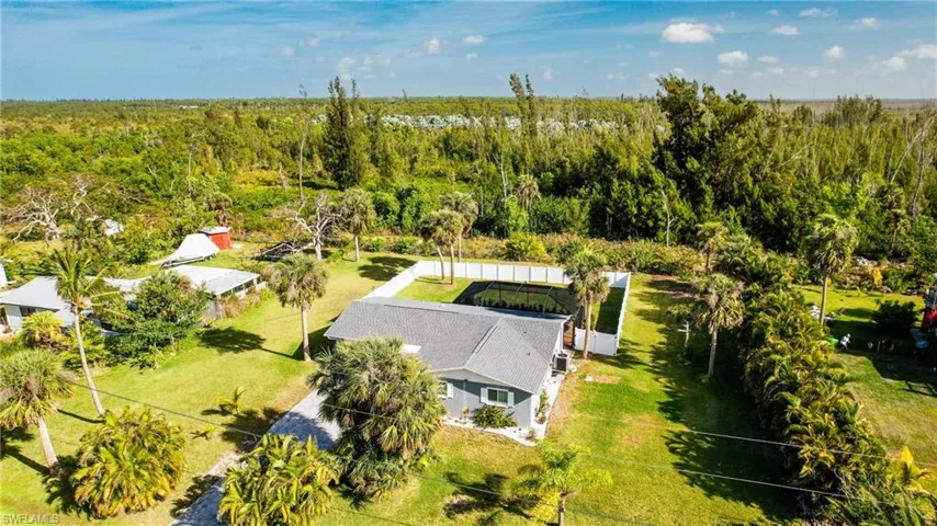Birds eye view of property with a view of trees
