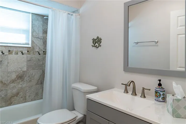 Full bathroom featuring shower / bath combo, toilet, and vanity