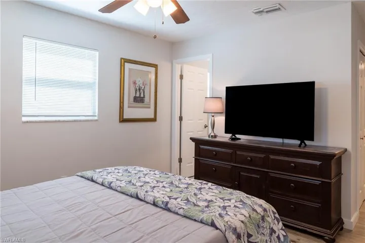 Bedroom with a ceiling fan and visible vents